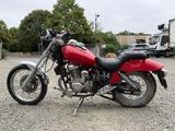 a red motorcycle that is parked in a parking lot