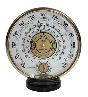 a clock that is on a stand on a white background