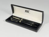 black and gold fountain pens in a black box on a white surface