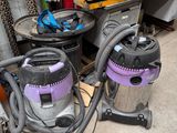 two vacuums that are sitting on the floor