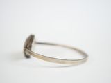 a close up of a silver ring with a stone in the middle