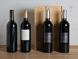 three bottles of red wine are lined up on a table