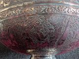 a large silver bowl sitting on top of a table