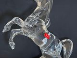 clear glass figurine of a horse with a rider on its back