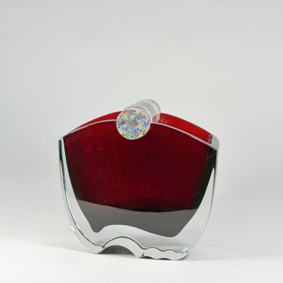 a red glass vase with a silver base on a white background