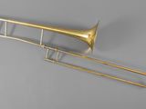 an old brass trombone with a long neck and a long horn