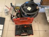 a red box with a vacuum on it and tools on the floor