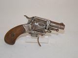 an old revolver with a wooden handle on a white surface