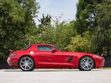 the red mercedes sls is parked on the side of the road