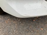a close up of the front bumper of a white car