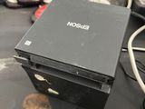 a black box sitting on top of a black table