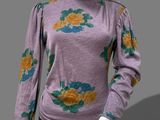 an image of a mannequin mannequin wearing a purple top with flowers on it