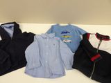 several children ' s clothing are lined up on a white table