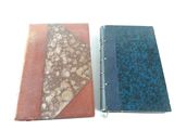 two books sitting side by side on a white surface