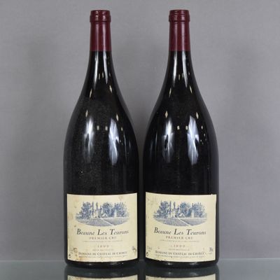 two bottles of red wine sitting on top of a glass table