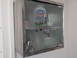 a metal box with toothbrushes and toothpaste on it