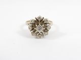 a white gold ring with a cluster of diamonds in the center