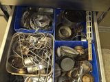 a drawer full of dirty dishes and utensils in the kitchen