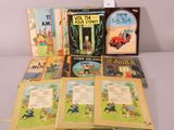 several children ' s books are lined up on a table