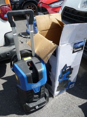 a blue and black cleaning machine next to a box of boxes