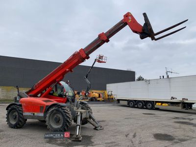 the forklift is parked in front of a trailer in a parking lot