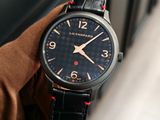 a close up of a person ' s hand holding a watch