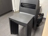 a grey chair and a table in a room