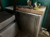an image of a kitchen with a refrigerator and a chair