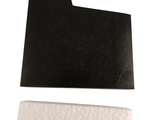 a piece of black paper and a piece of white paper on a white surface