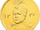 a close up of a gold coin with an image of a man wearing a hat