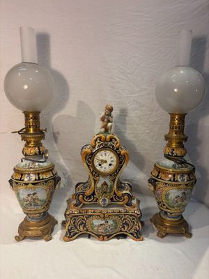 three vases and a clock sitting on a table