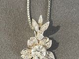 silver plated necklace with a flower pendant and a chain