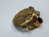 a gold locke with a chain around it on a white surface