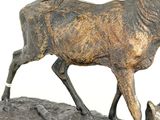 statue of a stag and a cat on a rock
