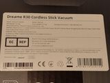 the back of a black and white box with a sticker on it
