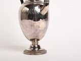 a silver vase with a handle on a white background