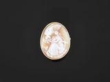 an oval shell cameo of a woman holding a child