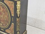 a black and gold cabinet with a marble top