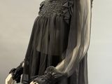 an image of a mannequin wearing a black top and skirt