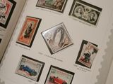 an open book with stamps on it on a table