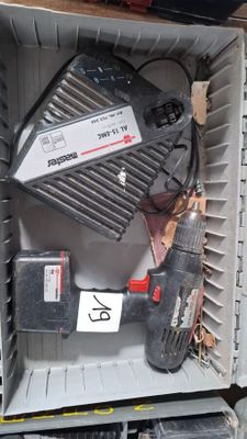 a box with a drill and other tools inside of it