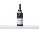 bottle of red wine sitting on top of a white table