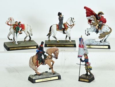 several figurines of people riding horses with flags on them