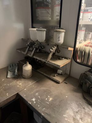 a picture of a workbench with a lot of clutter on it