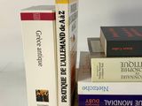 several books are stacked on top of each other on a table
