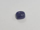 a close up of a blue stone on a white surface