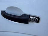 a black handle on a white car door handle