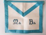 an image of a blue and white apron with a monogram on it