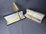 pair of silverware in a box with a knife inside of it