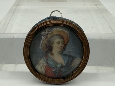 a miniature picture of a woman in a hat on display